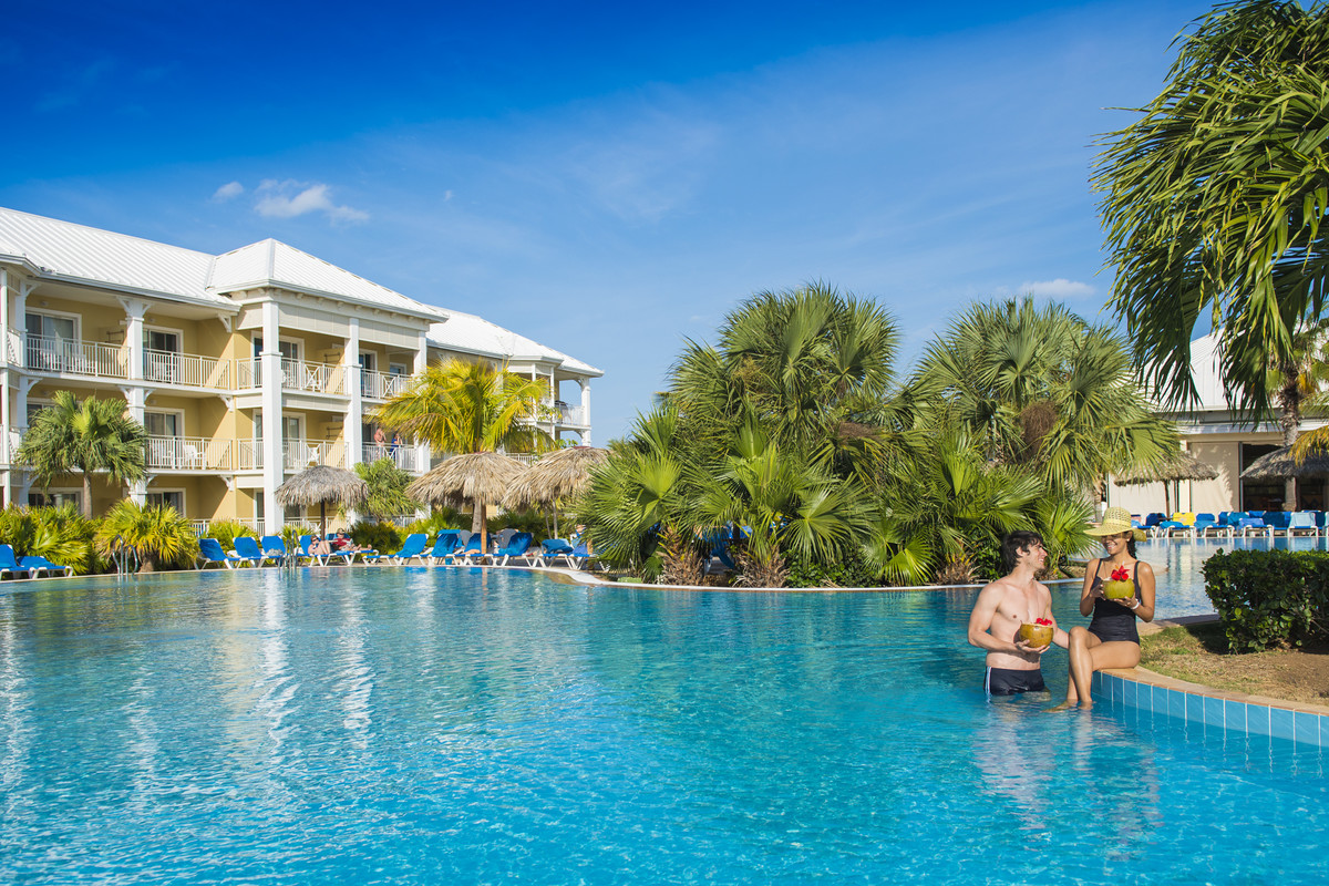 Sipping a drink around the pool is the perfect way to start your vacation