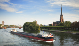 Barge moving along Main River - Frankfurt, Germany